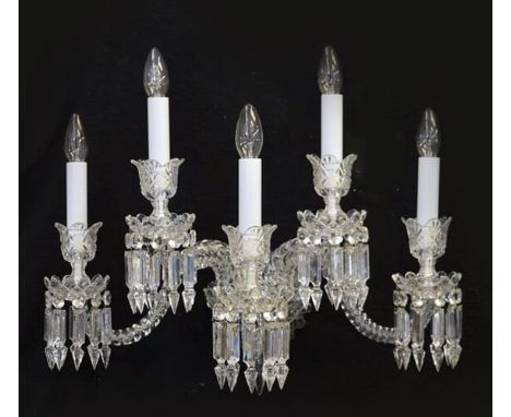 A pair of Baccarat cut and moulded clear glass five light wall appliquesthe spiral scrolling arms supporting diamond cut scal