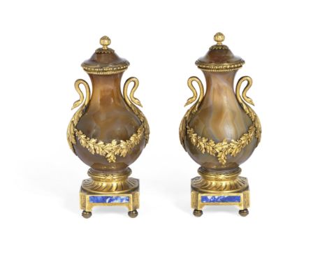 A pair of late 19th century gilt bronze mounted agate garniture urns and coversin the Louis XVI stylethe pear-shaped pedestal