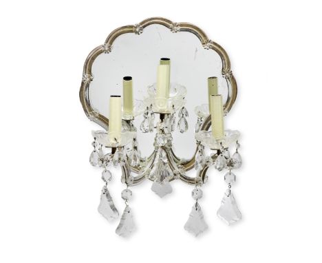 A set of four mid-20th century three light clear glass and mirrored girandolesprobably Austrian or Venetianthe scrolling arms