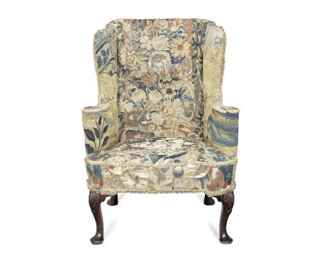 A 19th century mahogany wingback armchair upholstered with early 18th century tapestry fragmentsThe tapestry upholstery depic