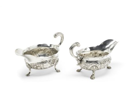 A pair of George II silver sauce boatsJohn Pollock, London 1749 Shaped-oval form, with embossed Rococo decoration, on three h