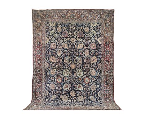 A Tabriz carpetNorth West Persia,the blue field with overall polychrome palmettes and flowering vines within soft red palmett