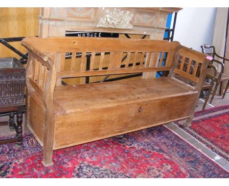 A vintage central European pine bench with scroll ends and storage compartment under seat - length 200cm 