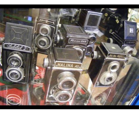 Seven assorted vintage cameras including Halina and Ricoh