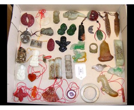 A selection of carved jade pendants and other