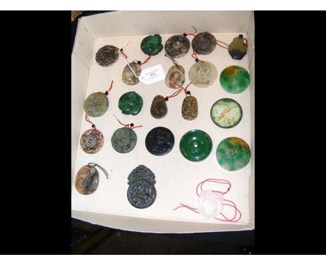 A selection of carved jade pendants and other