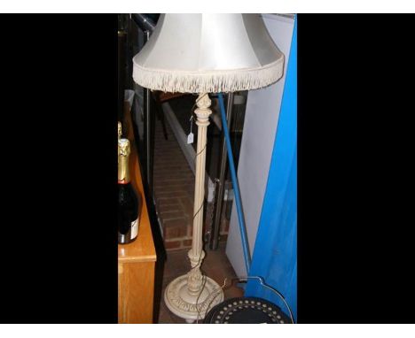 A standard lamp with tasselled shade 