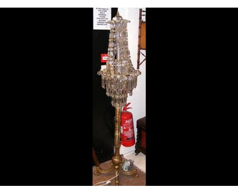 A gilt decorated standard lamp with glass lustre shade - height 175cm 