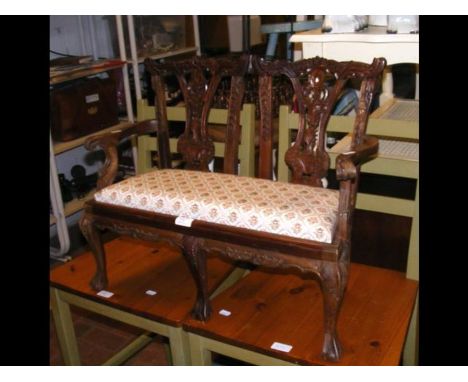 A reproduction miniature mahogany Chippendale style settee 
