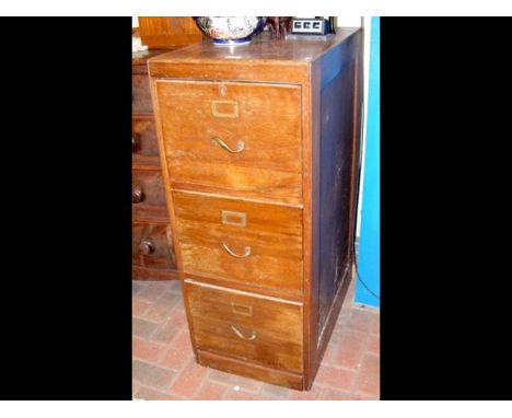 A vintage wooden filing cabinet of three drawers and featuring unusual twisted handles - width 44cms