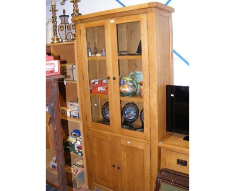 A light oak cabinet with glazed upper half and cupboard below - width 95cms