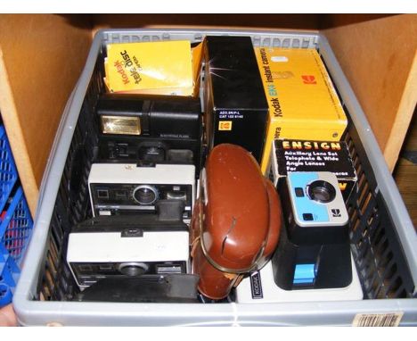 A box of assorted vintage cameras, including Kodak and various instant cameras 