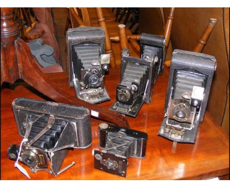 Six vintage folding cameras including Kodak