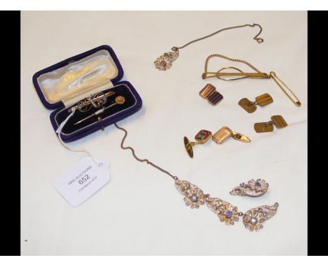 A gold brooch, stick pin etc.