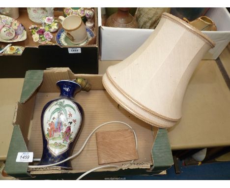 An Oriental lamp base depicting a boy picking flowers, with beige shade, a/f.