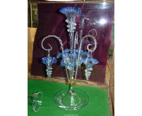 A blue glass Epergne with central trumpet, three lower trumpets and three hanging baskets, 24'' tall overall.