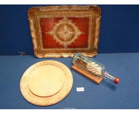 A quantity of miscellanea to include a vintage round wooden bread board, papier mache red/gold patterned tray and Italian pri