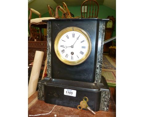 A black slate Mantle clock, some damage to top, having white enamel face with Roman numerals, with key and pendulum, 8 1/2" w