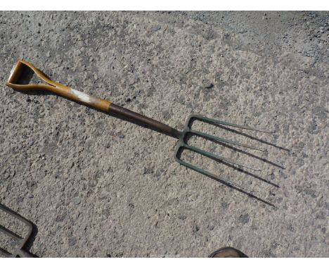 A high quality four-pronged garden fork having a stirrup type handle and stamped with the makers' name "Bulldog, English Tool