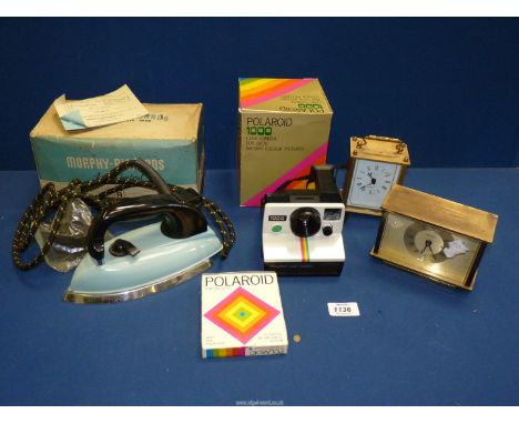 A Polaroid 1000 Land camera with unopened pack of ten instant photo cards together with a vintage iron by Morphy Richards, du