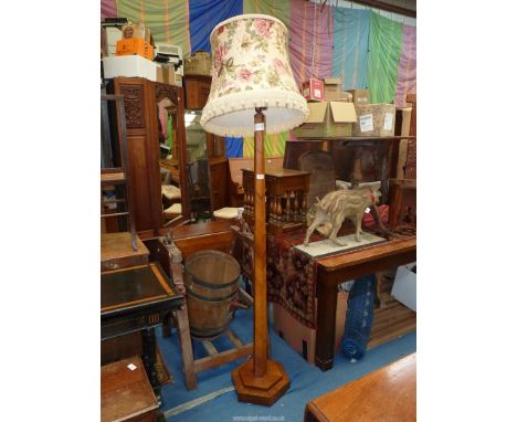 A hexagonal pillared Walnut standard Lamp complete with a rose bloom decorated fringed shade.