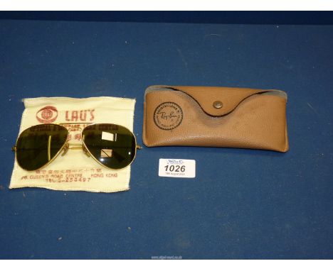 A pair of vintage Ray-Ban Aviator sunglasses with impact resistant lenses by Bausch & Lomb, apparently purchased in Hong-Kong