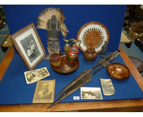 A quantity of treen including bowls, storage jar, bread board, ethnic mask and spears, terracotta army figure, old photograph