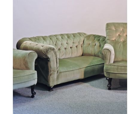 An Edwardian green upholstered button back chesterfield sofa, 164cm, together with a pair of Victorian armchairs