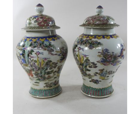 A pair of Chinese Canton porcelain ginger jars and covers, decorated with figures, 40cm high