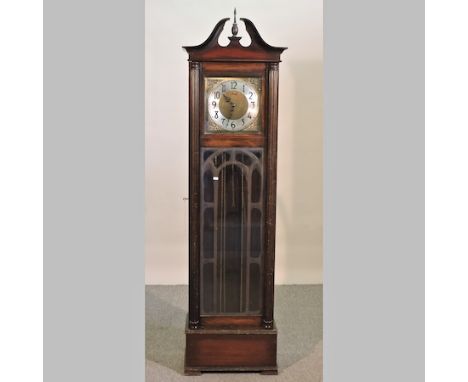 A 1920's oak cased longcase clock, having a glazed case, the three train movement, with Westminster chimes, 201cm high