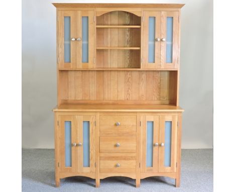 A modern light oak dresser, with glazed cupboards and drawers below, 136cm