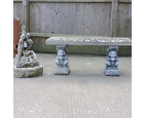 A stone bench, 110cm, together with a water feature