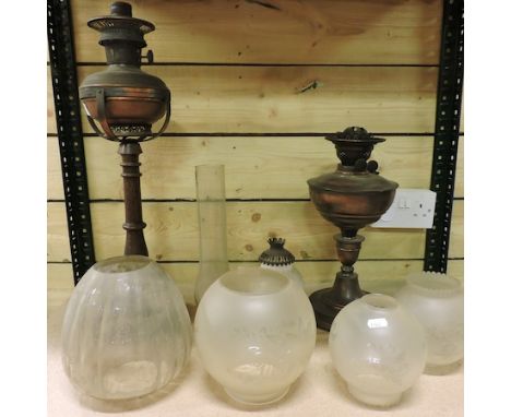 A 19th century oil lamp, together with another and various glass shades