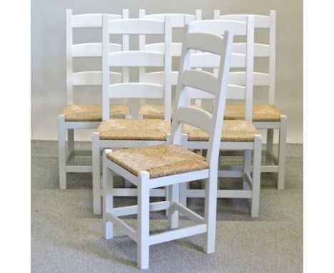 A set of six white painted ladder back dining chairs, with rush seats