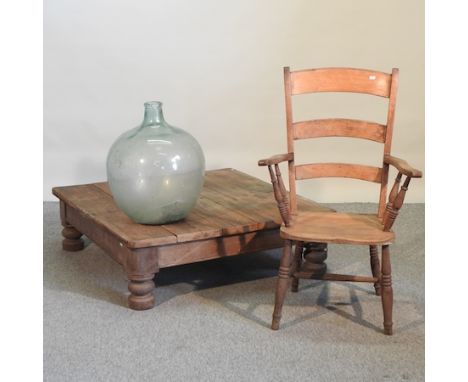 A square pine coffee table, 108cm, together with a 19th century ladder back armchair and a glass carboy