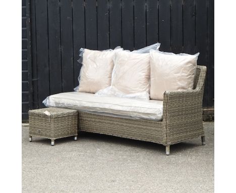 A beige three seater garden sofa, 173cm, with loose cushions, together with a matching coffee table