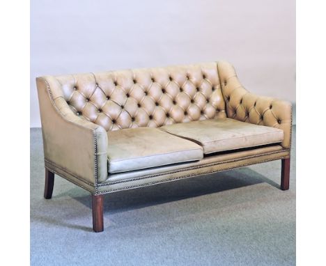 A green leather upholstered button back sofa, 135cm