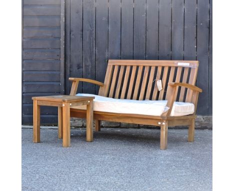 A teak Balmoral garden bench, with a loose cushion, 150cm, together with a teak occasional table