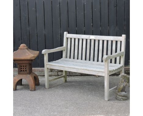 A garden bench, 120cm, together with a stone otter and a stone lantern