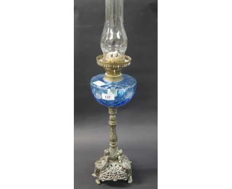 A large oil burner lamp with a decorative and ornate base with three figures of young ladies to the base of the lamp