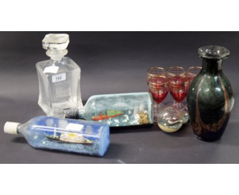 A sundry lot of glass to include three ships in various bottles, plus a set of 6 cranberry-coloured glasses and a decanter an