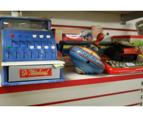 A sundry lot of vintage toys to include cash register, a spinning top, tin plate typewriter, shop scales and a jack-in-the-bo