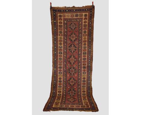 Luri runner, south west Persia, early 20th century, 10ft. 6in. X 4ft. 3in. 3.20m. X 1.30m.  Overall wear with corrosion to da