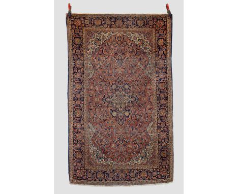 Two Persian rugs: The first: Kashan rug, west Persia, circa 1920s-30s 6ft. 9in. X 4ft. 3in. 2.05m. x 1.30m. Overall even wear