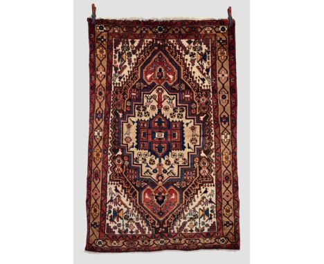 Hamadan rug, north west Persia, circa 1950s, 6ft. 7in. X 4ft. 2in. 2.01m. X 1.27m. Step-sided dark blue field with camel cent