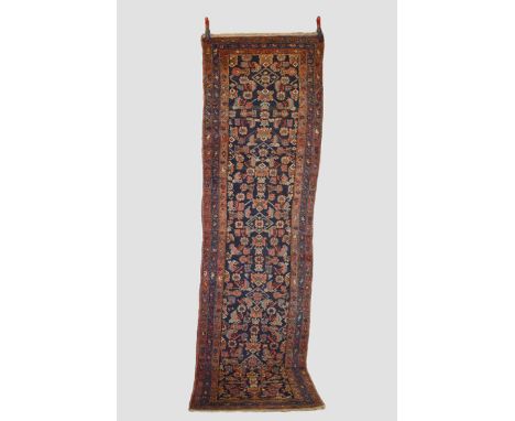 North west Persian runner, Hamadan area, circa 1930s-40s, 10ft. X 2ft. 10in. 3.05m. X 0.86m. Dark blue field with all over he