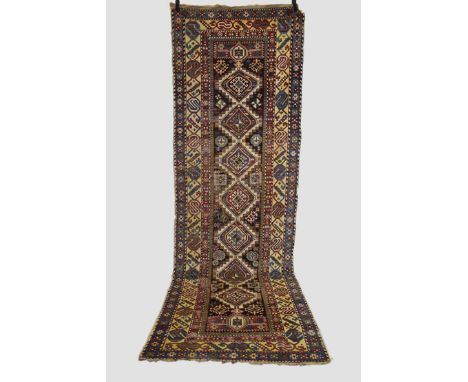 Shirvan runner, south east Caucasus, late 19th century, 12ft. 3in. X 3ft. 11in. 3.73m. X 1.20m. Overall wear with corrosion t