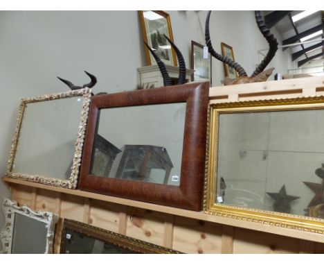 A large cushion framed wall mirror together with a gilt framed bevel edged mirror and a shell framed mirror.
