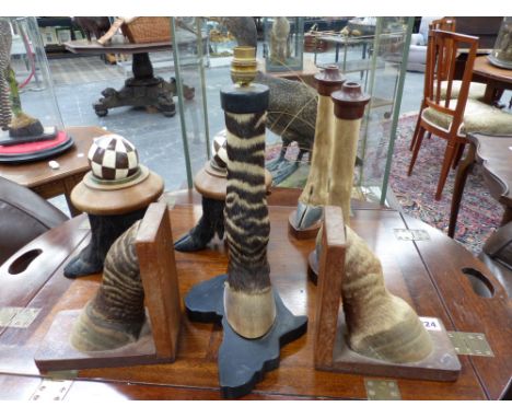 Taxidermy: A pair of zebra hoof bookends, a similar table lamp and other feet.