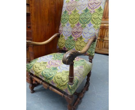 A large 17th.c.style highback armchair with tapestry upholstery.